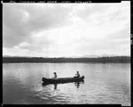 A Couple In A Canoe On A Lake, Mountains In Background Highlighted By Sunlight On Lake Kezar In Lovell by George French