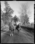 Two Women Riding Horses On A Gravel Trail In Porter by George French