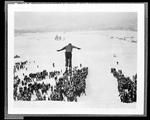 Person Coming Off A Ski Jump, Crowd Gathered Below by George W. French