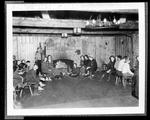 People Gathered Around The Fire At A Ski Lodge by George W. French