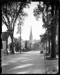 Tree Lined Street With Homes And A Church In Brunswick by George French