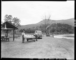A Couple Unloading A Canoe From A Trailer At Chain Of Ponds by George French