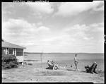 Family Enjoying Themselves On Shore And Lawn At A Camp In Harpswell by George French