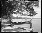 A Couple Carrying A Canoe Towards The Water At Camp Wavus In Jefferson by George French