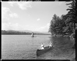 Two Women In Canoe Just Off Shore In Kezar Lake At Lovell by George French