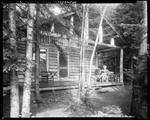 Woman Sitting Reading On A Camp Porch At Moosehead by George French
