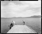 Three Men On A Dock At Moosehead Lake by George French