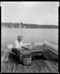 Man Kneeling Over A Basket Full Of Lobsters In North Edgecomb by George French