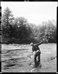 Man Standing In A Stream In Porter Fishing, Has A Fish He Is Netting At Kimball Falls by George French