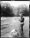 Man Standing In Stream Fishing, Two Fish He Caught Lying On Rock Nearby In Porter by George French
