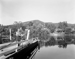 Man Standing On A Cable Ferry At A River Crossing In Rumford Point by George French
