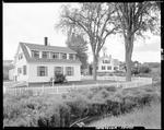 Cape Style Home With White Picket Fence Around Front Yard In Waldoboro by George French