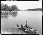 Two Boys Unloading Clams From A Boat Near Shore In Harpswell by George French