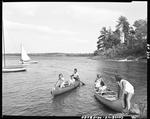 Six Girls In Two Canoes, One Beached The Other Just Off Shore In Fryeburg by George French