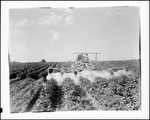 Worker Using A Tractor To Dust A Potato Crop In Monticello by George French