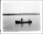 Two Men Fishing From A Boat In The Middle Of A Lake, One Netting Fish by George French