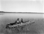 Two Duck Hunters Sitting In A Camouflaged Boat by George French