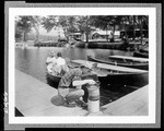 Man On A Dock Preparing Live Bait For A Fishing Expedition by George French