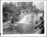 Two Men Fly-Fishing Near Falls, One Netting Others Catch by George French