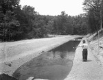 Two Men Standing Near A Fish Hatchery Canal In Lovell by George French