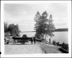 Men Loading A Canoe Onto A Trailer by George French