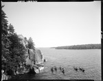 Group Of Canoeists Near A Bluff On Sebago Lake, Motor Boat Tied In At Base Of Bluff by George French