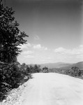 Gravel Road On A Hilltop With View Of Lake And Surrounding Mountains "Houghton Road" by George French