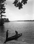 Two Men At Edge Of Lake Getting Ready To Go Out Fishing In A Canoe by George French