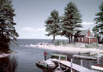 Fisherman On Dock By Boats At Sebago Lake by George French