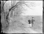 Young Boy And Girl Walking Along A Hedgerow Toward Distant Houses by George French