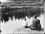 Grandfather And Grandson Sitting On A Rock Fishing by George French