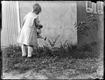 Young Girl Watering Plants Outside A House by George French