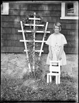 Young Girl Standing With A Child's Chair And Next To A Trellis Outside A House by George French