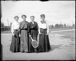 Four Women With Tennis Racquets And Balls On A Tennis Court by George French