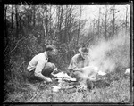 George French And A Member Of The Boy Scouts Of America Cooking Over An Open Fire In The Woods. by George French