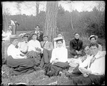 Group Of People Sitting On The Grass Under A Tree by George French