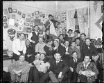 Large Group Of College Students Gather In A Dorm Room by George French