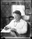 Woman Sitting At A Desk Writing A Letter by George French