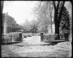 Snow Covered Driveway Leading Up To A Large House by George French