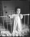 Baby Standing In A Crib by George French