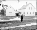 Man Standing On Dirt Road In Front Of A House by George French