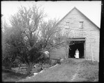 Woman Holding A Pail Standing In The Doorway Of A Barn by George French