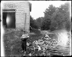 George French Outside A Barn With An Arm Load Of Wood by George French