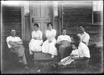 French Family Seated Outside Of House by George French