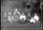 Family Group Sitting On Lawn Outside Of A Home by George French