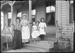 Three Women And Two Children On Front Porch Of A Home by George French