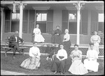 Eight Women And One Man Sitting On The Lawn And Veranda Outside A House by George French