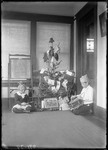 Two Children Playing With Toys In Front Of A Christmas Tree by George French