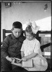 Young Boy & Girl Reading A Book Together by George French