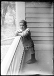 Young Boy Leaning On A Porch Rail by George French